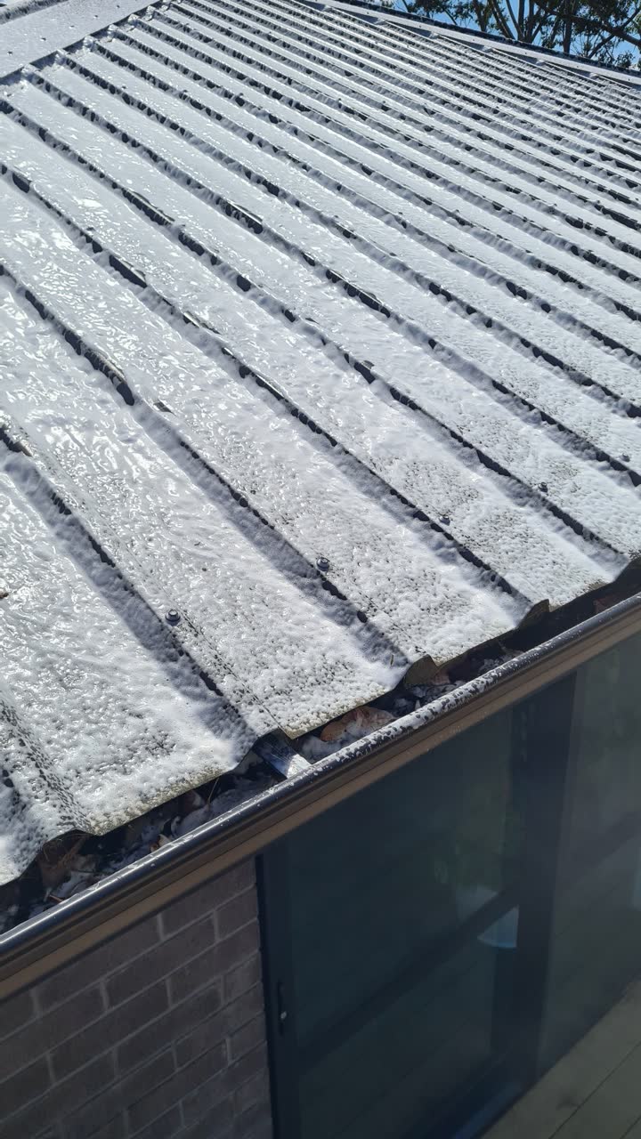 A roof treatment being applied to clear moss and mould
